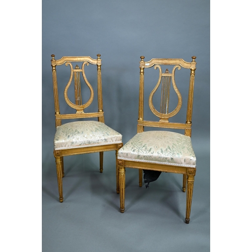 900 - A pair of 19th century Empire giltwood side/music chairs with lyre-back splats (2)