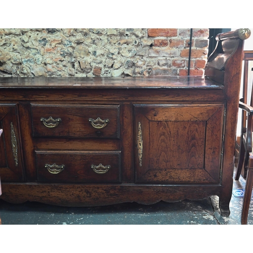 901 - An 18th century oak low dresser / sideboard, of unusual form, the top with raised gallery ends incor... 