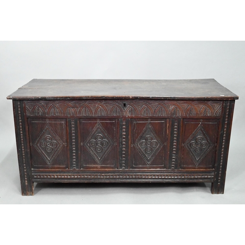 906 - A late 17th century carved oak coffer, the two plank top over a lunette carved frieze and four incis... 