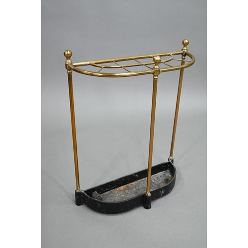 908 - An old open brass framed ten division stick stand, of demi-lune form with cast iron drip tray, 48 cm... 