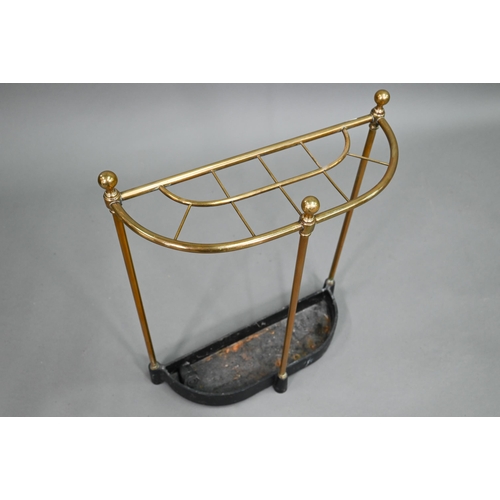 908 - An old open brass framed ten division stick stand, of demi-lune form with cast iron drip tray, 48 cm... 