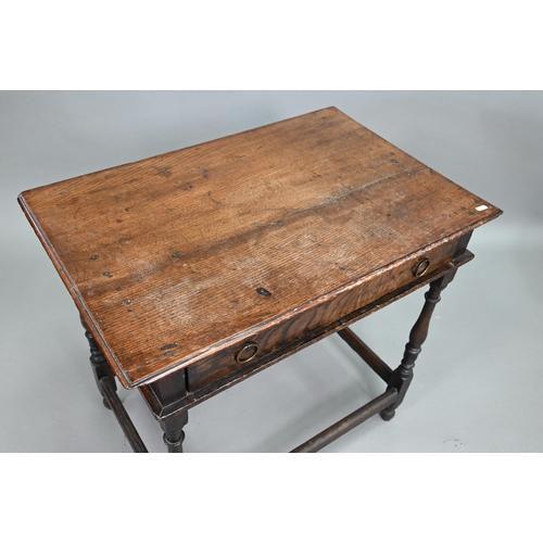 910 - An 18th century oak side table with single drawer, raised on a turned frame united by all-round stre... 