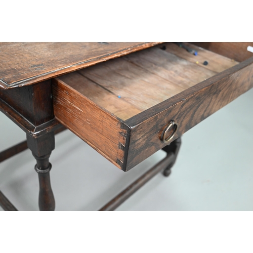 910 - An 18th century oak side table with single drawer, raised on a turned frame united by all-round stre... 