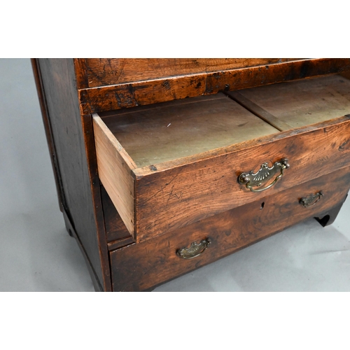 915 - An 18th century and later composed oak and elm chest, the hinged top over three long graduated drawe... 