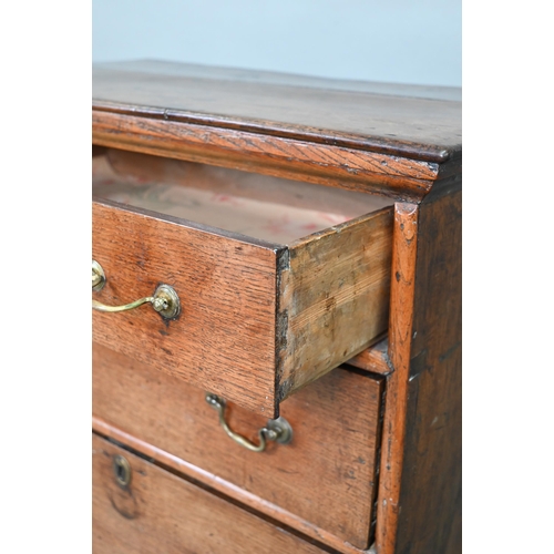 916 - An 18th century oak chest on stand, of diminutive proportions comprising three long graduated drawer... 