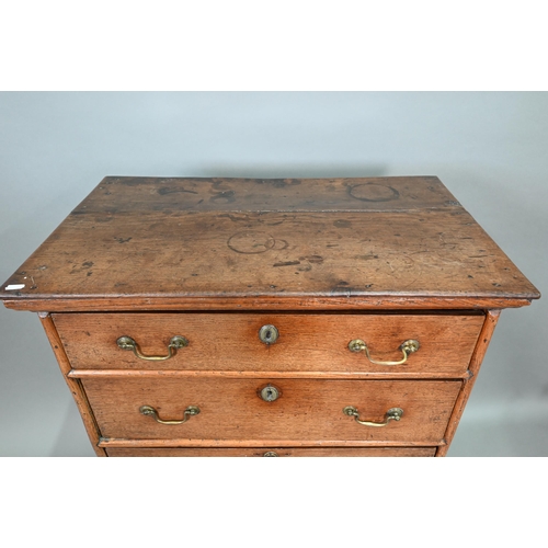 916 - An 18th century oak chest on stand, of diminutive proportions comprising three long graduated drawer... 