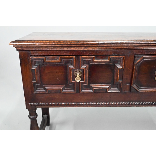 940 - An 18th century oak three low dresser, the single wide plank top over a trio of frieze drawers with ... 