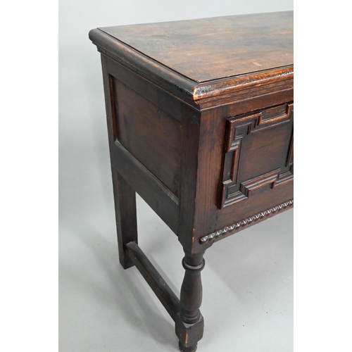 940 - An 18th century oak three low dresser, the single wide plank top over a trio of frieze drawers with ... 