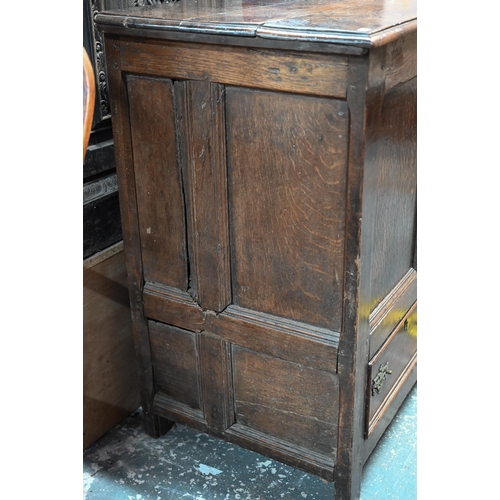 942 - A Georgian oak mule chest, the hinged top with moulded edge over a triple panelled front over two dr... 