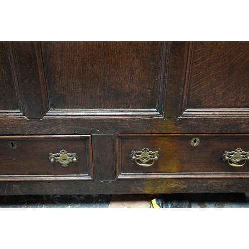 942 - A Georgian oak mule chest, the hinged top with moulded edge over a triple panelled front over two dr... 