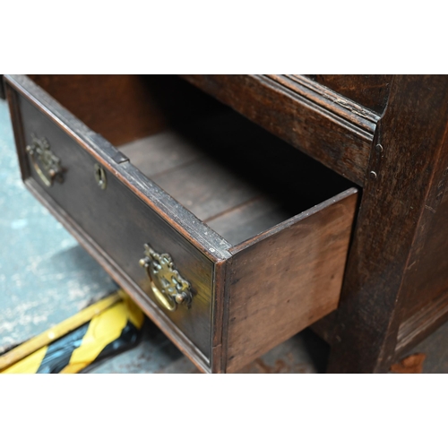 942 - A Georgian oak mule chest, the hinged top with moulded edge over a triple panelled front over two dr... 