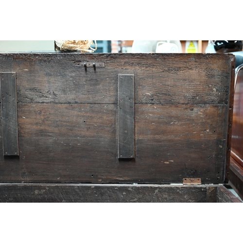 942 - A Georgian oak mule chest, the hinged top with moulded edge over a triple panelled front over two dr... 