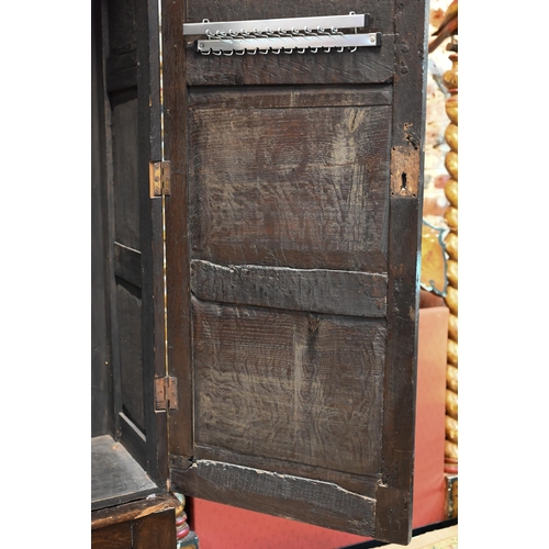 951 - An 18th century and later composed oak two section linen cupboard, the pair of joint framed triple p... 