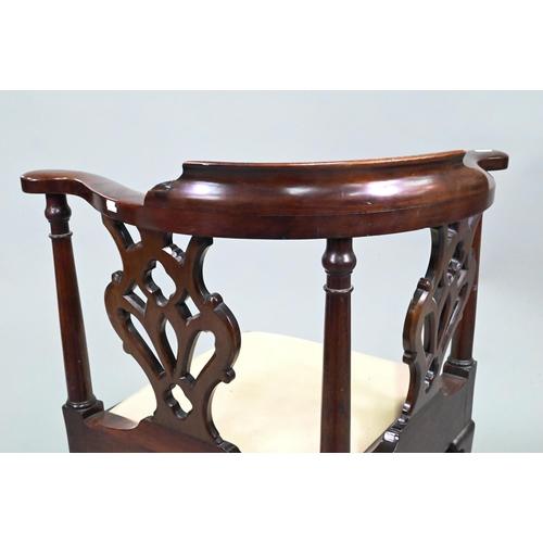 959 - A Georgian mahogany corner chair, with twin pierced vase shape splats flanked by turned pilasters, o... 