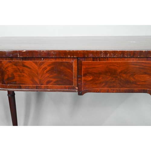 962 - A Victorian cross-banded mahogany bow-fronted serving table, with three frieze drawers, raised on sl... 