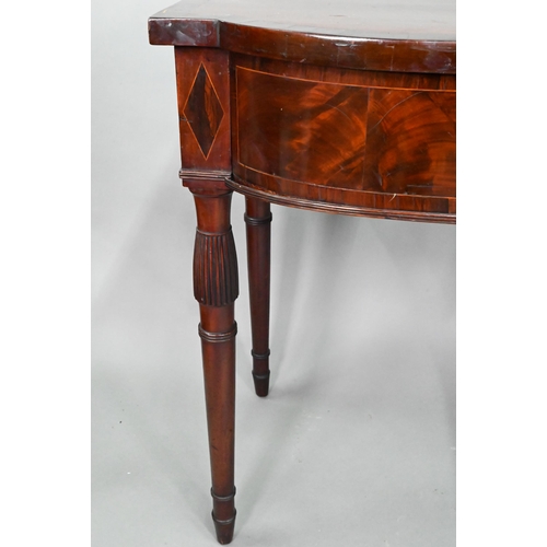 962 - A Victorian cross-banded mahogany bow-fronted serving table, with three frieze drawers, raised on sl... 