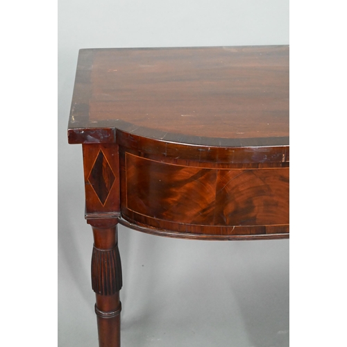 962 - A Victorian cross-banded mahogany bow-fronted serving table, with three frieze drawers, raised on sl... 