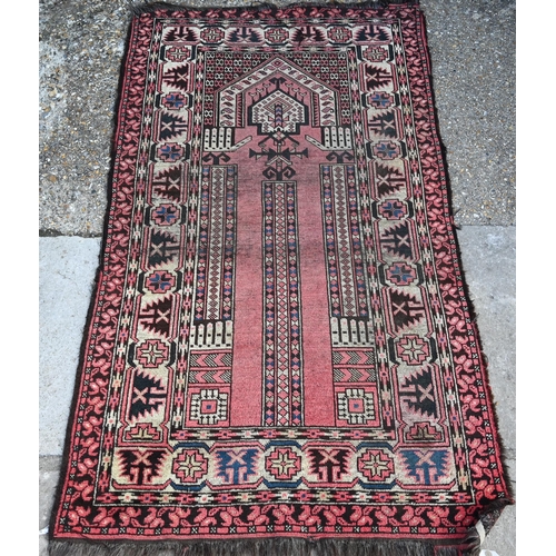 801 - An antique Caucasian Red ground prayer rug, the geometric deign on crimson ground, 166 cm x 95 cmPro... 