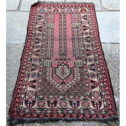 801 - An antique Caucasian Red ground prayer rug, the geometric deign on crimson ground, 166 cm x 95 cmPro... 