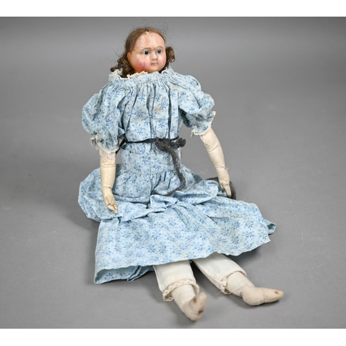 1159 - A 19th century wax-headed girl-doll with brown wig and fixed brown eyes, on stuffed fabric body with... 