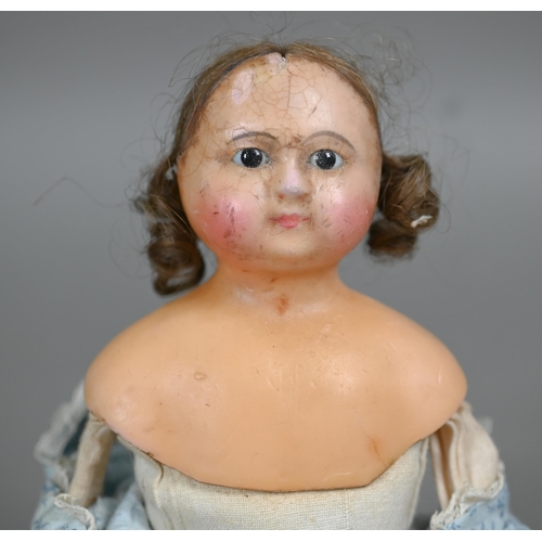 1159 - A 19th century wax-headed girl-doll with brown wig and fixed brown eyes, on stuffed fabric body with... 