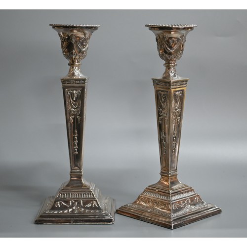 40A - Two pairs of Adam revival loaded silver candlesticks decorated with repoussé rams heads and neoclass... 
