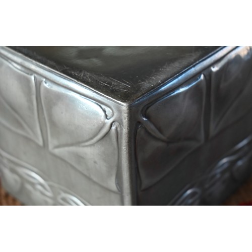 1082 - An Art Nouveau pewter biscuit box and cover of cube form with embossed stylised foliage, in the mann... 