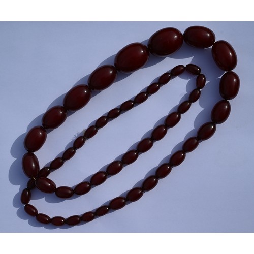 277 - Three rows of graduated amber beads including one cherry red, approx 183g (3)