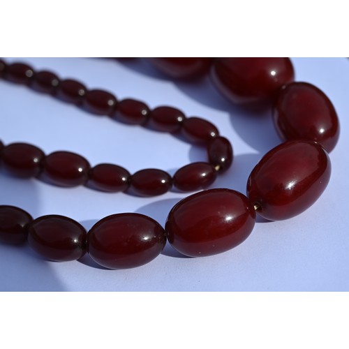 277 - Three rows of graduated amber beads including one cherry red, approx 183g (3)