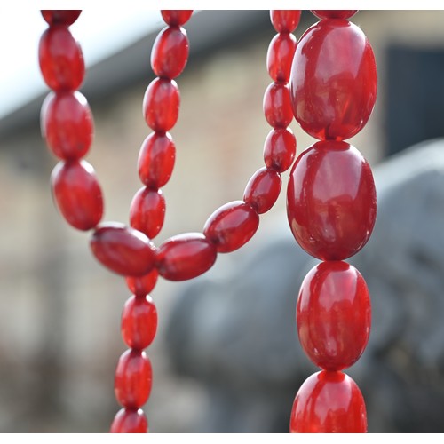 277 - Three rows of graduated amber beads including one cherry red, approx 183g (3)