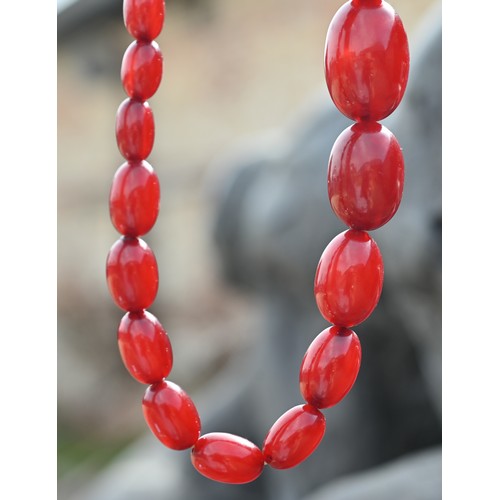 277 - Three rows of graduated amber beads including one cherry red, approx 183g (3)