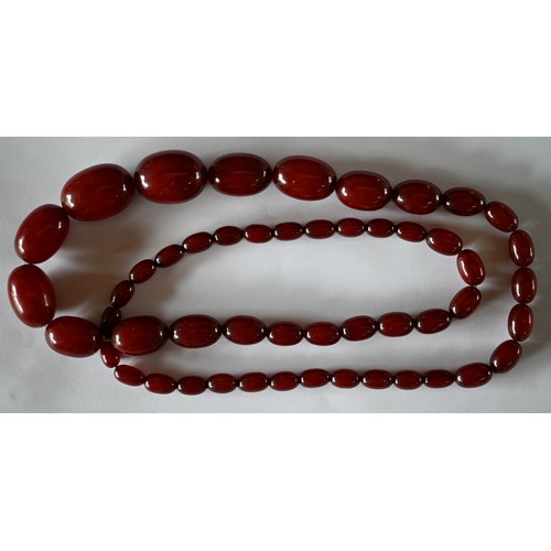 277 - Three rows of graduated amber beads including one cherry red, approx 183g (3)