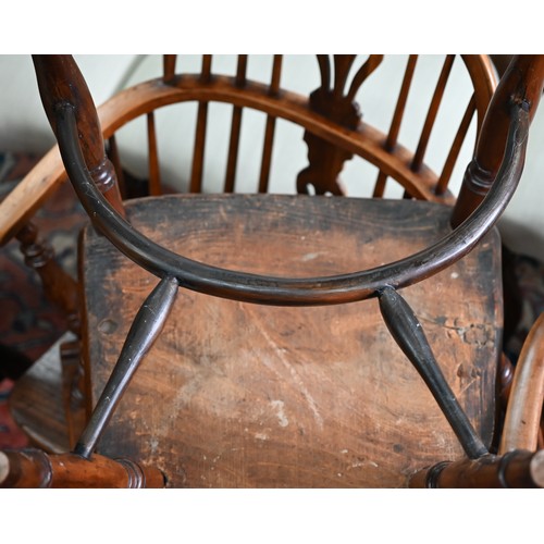 892 - An antique yew and elm Windsor high splat-back armchair, Lincolnshire, with crinoline stretcher