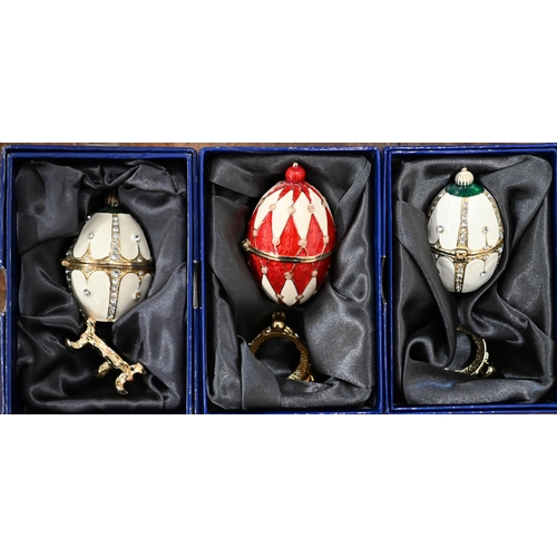 165 - Six Atlas Editions Fabergé eggs (three boxed) to/w an urn and an egg pendant (8)