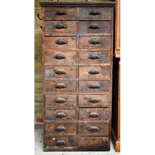 31 - An antique stained pine twenty drawer chest, ex shop fitting, with cast metal fittings (one missing)... 