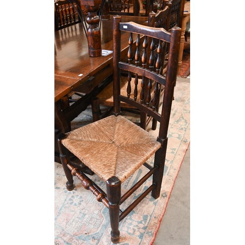 A set of eight ash and beech Lancashire spindle-back dining chairs with woven rush seats (8)