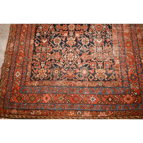 441 - A North West Persian wide runner (very worn), with floral design on navy ground with red/blue border... 