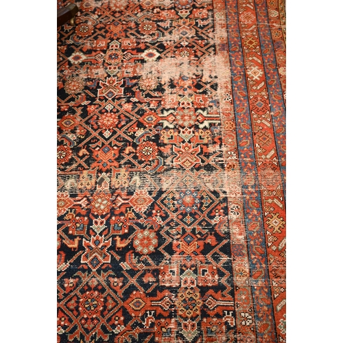 441 - A North West Persian wide runner (very worn), with floral design on navy ground with red/blue border... 