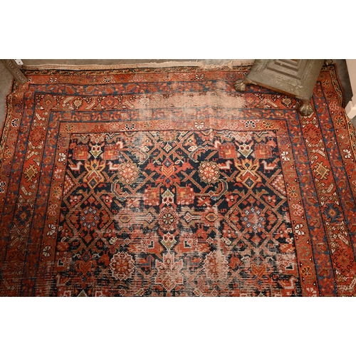 441 - A North West Persian wide runner (very worn), with floral design on navy ground with red/blue border... 