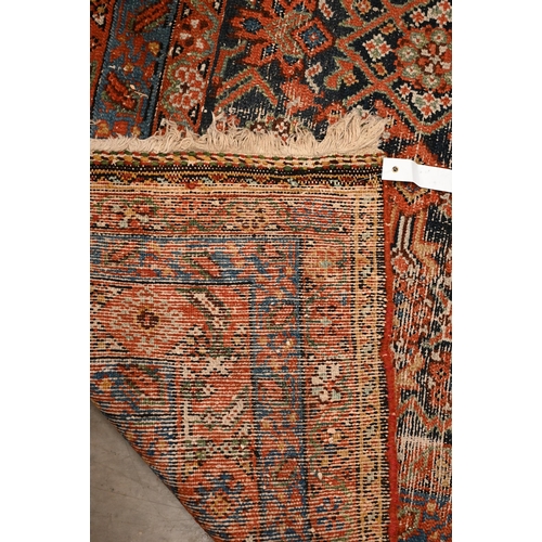 441 - A North West Persian wide runner (very worn), with floral design on navy ground with red/blue border... 