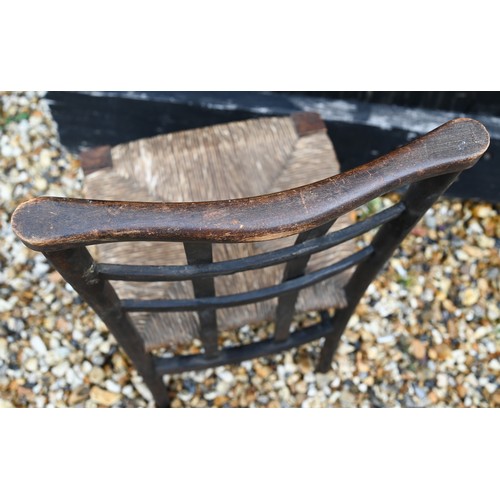 261 - An early 20th century Liberty style beech children's chair with rush-work seat