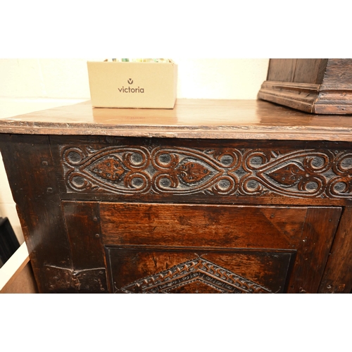 262 - An antique carved oak cupboard with panelled doors (a/f), 135 x 55 x 115 cm high