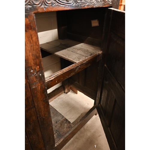 262 - An antique carved oak cupboard with panelled doors (a/f), 135 x 55 x 115 cm high