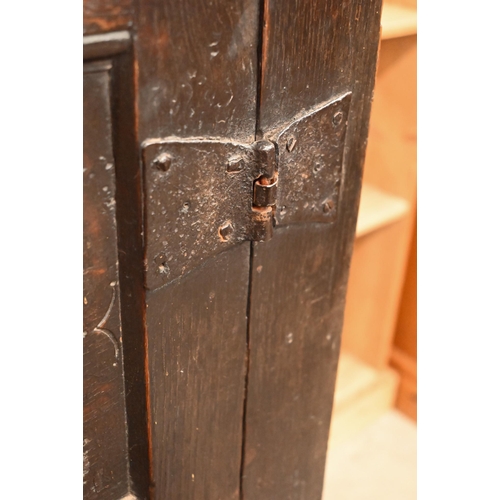 262 - An antique carved oak cupboard with panelled doors (a/f), 135 x 55 x 115 cm high