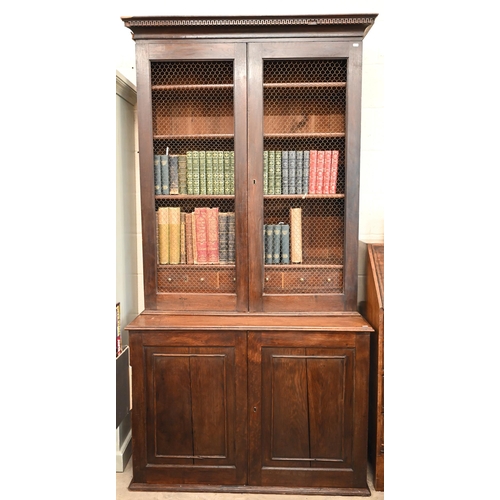 266 - An antique oak cabinet bookcase, the lattice wire panelled doors enclosing shelves and small drawers... 