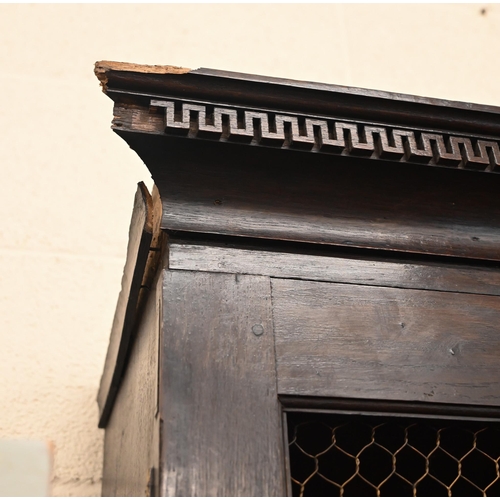 266 - An antique oak cabinet bookcase, the lattice wire panelled doors enclosing shelves and small drawers... 