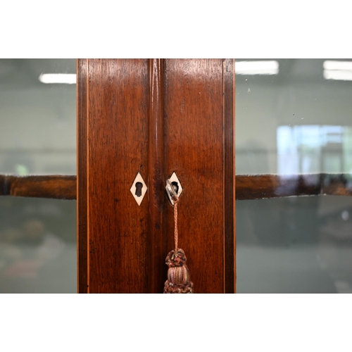 269 - A 19th century mahogany cabinet bookcase with glazed doors over panelled cupboards on bracket feet, ... 