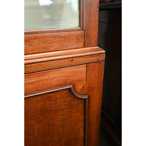 269 - A 19th century mahogany cabinet bookcase with glazed doors over panelled cupboards on bracket feet, ... 