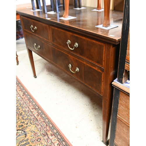 244 - An Edwardian cross-banded walnut three drawer sideboard, raised on square tapering legs on brass cas... 