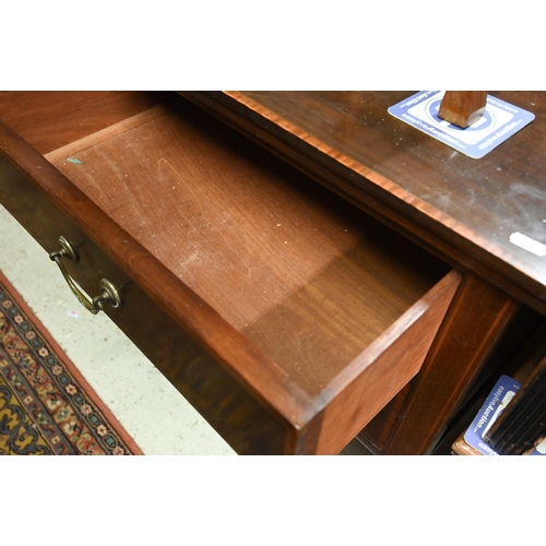 244 - An Edwardian cross-banded walnut three drawer sideboard, raised on square tapering legs on brass cas... 